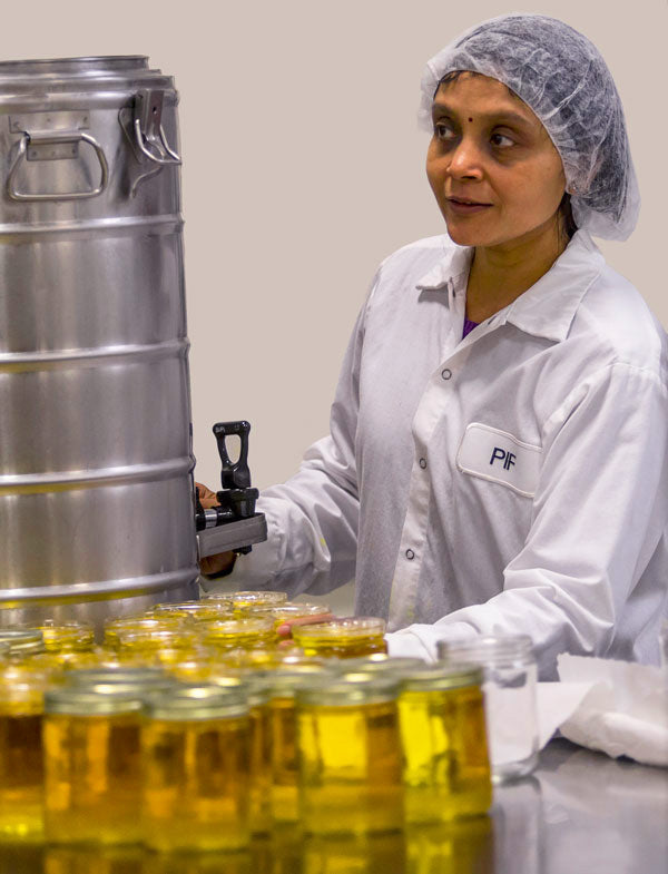 Nalini Agarwal of Pure Indian Foods filling ghee jars