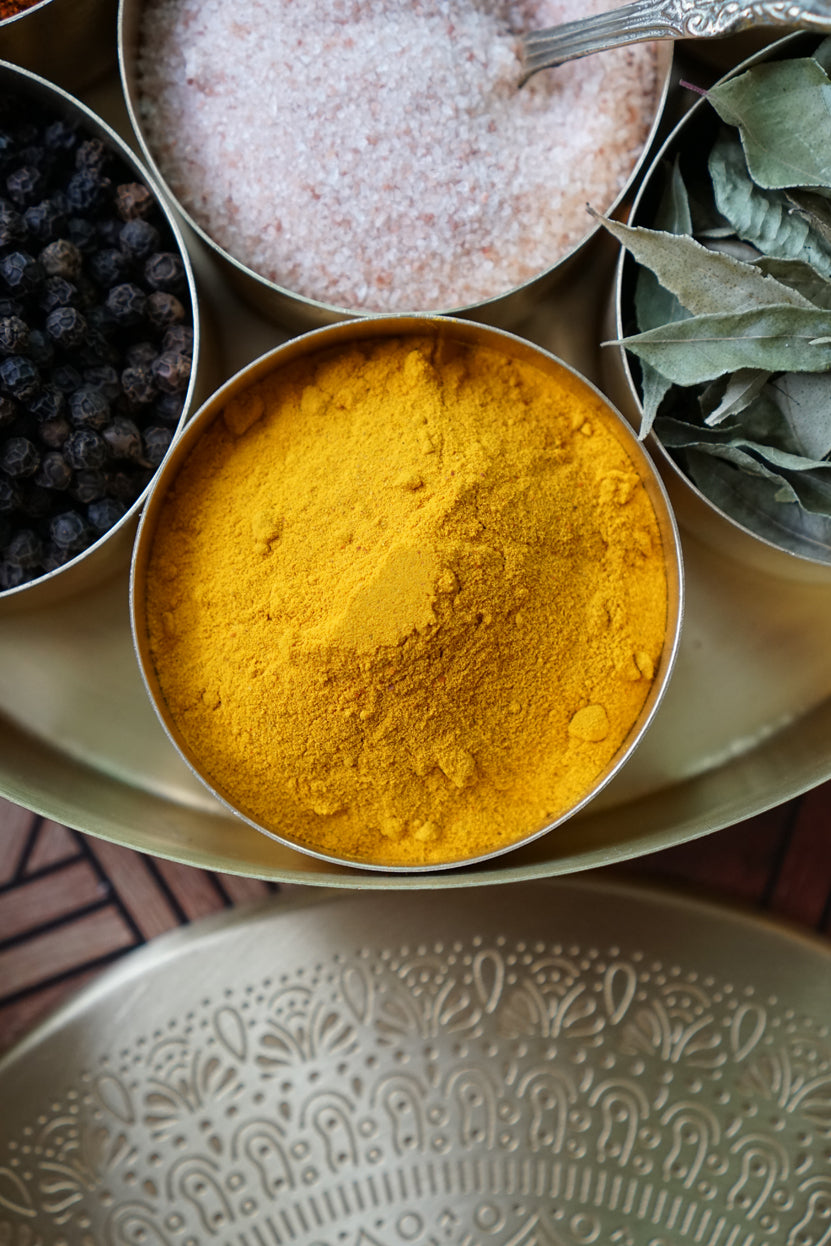 Pure turmeric powder stored in one of our brass masala dabbas.
