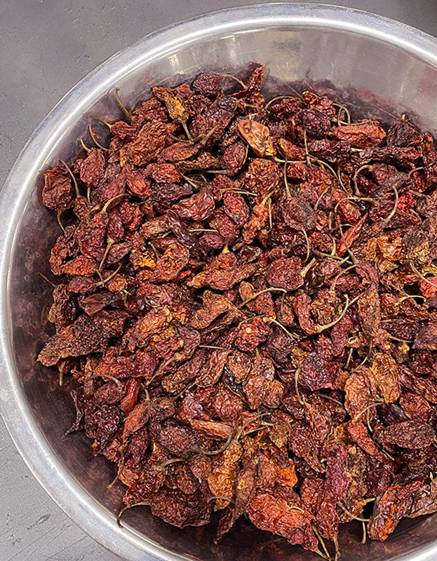 A bowl of whole dried organic smoked ghost peppers