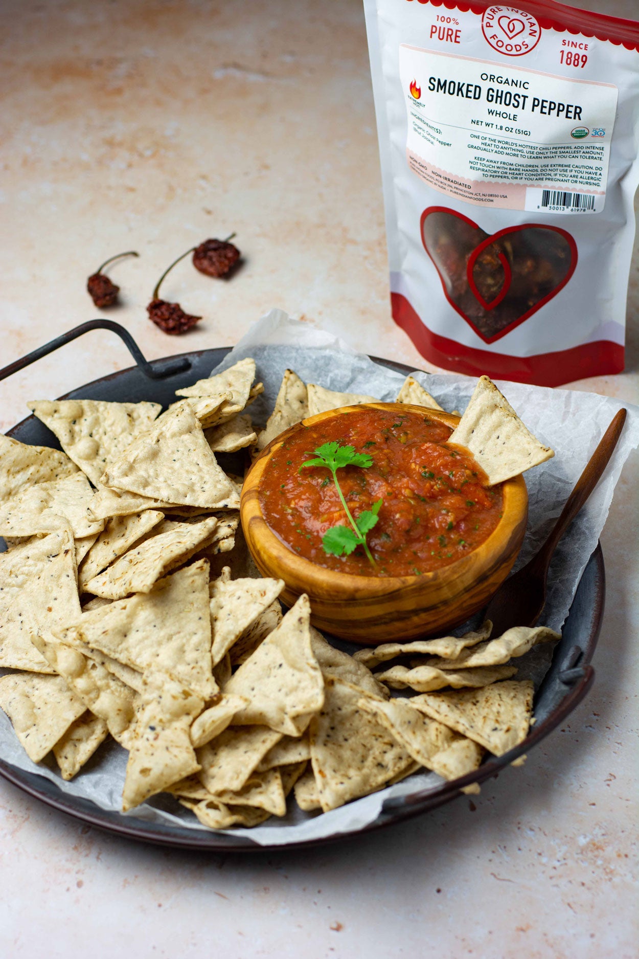 A serving platter of chips and salsa made with whole smoked ghost pepper from Pure Indian Foods