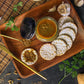 Our gluten-free organic Indian simmer sauce artfully displayed on a serving tray with crackers.