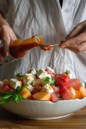 Adding a touch of our Mango Ghost Pepper Hot Sauce to a decadent fruit salad to give it a kick