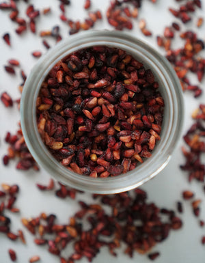 Birds eye view of an opened jar of dried pomegranate seeds from Pure Indian Foods.