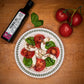 Birds eye view of a plate of caprese salad made with Primal Oil from Pure Indian Foods