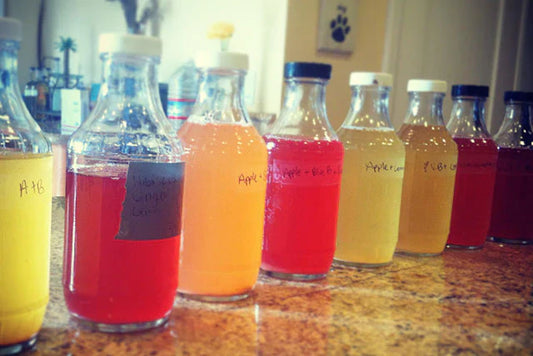 many jars of various fermented beverages made with jaggery lined up along a granite counter