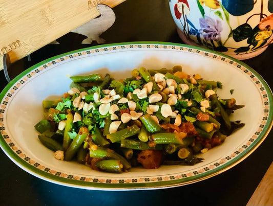 a bowl of green bean and tomato bhaji