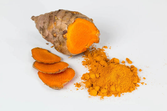 turmeric root next to slices and powder