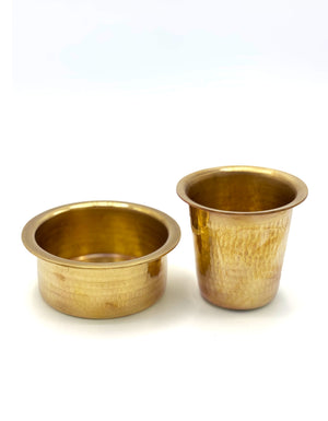 Two brass devara coffee tumbler cups on a white background