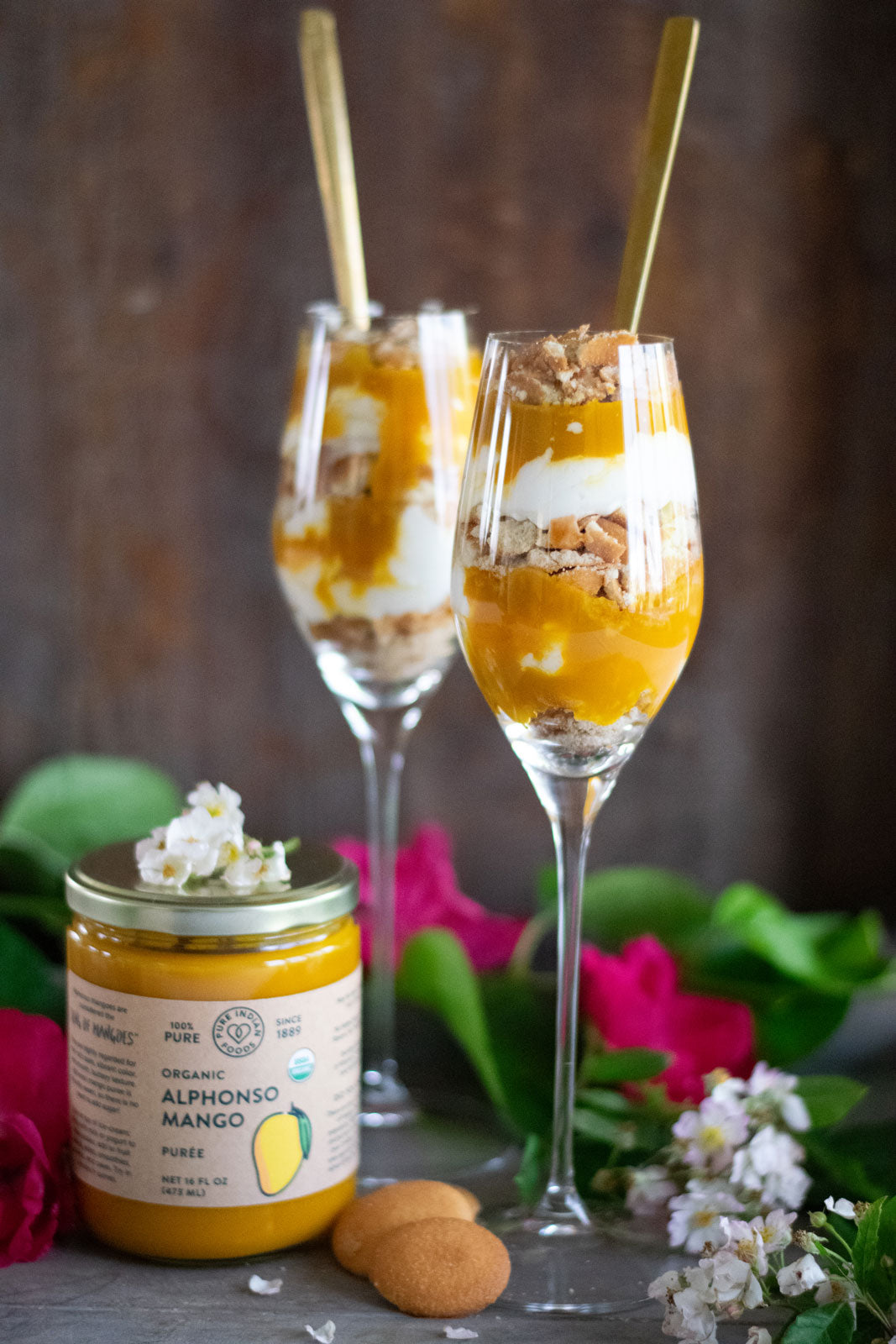 alphonso mango parfaits artistically displayed next to a jar of alphonso mango puree containing 100% pure organic mango pulp