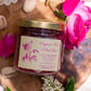 Jar of Organic Rose Petal Jam artfully displayed on a cutting board surrounded by roses and lace