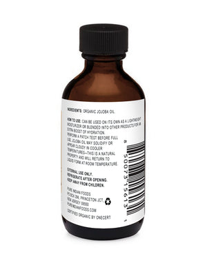 Back of a bottle of organic Jojoba oil showing ingredients label.