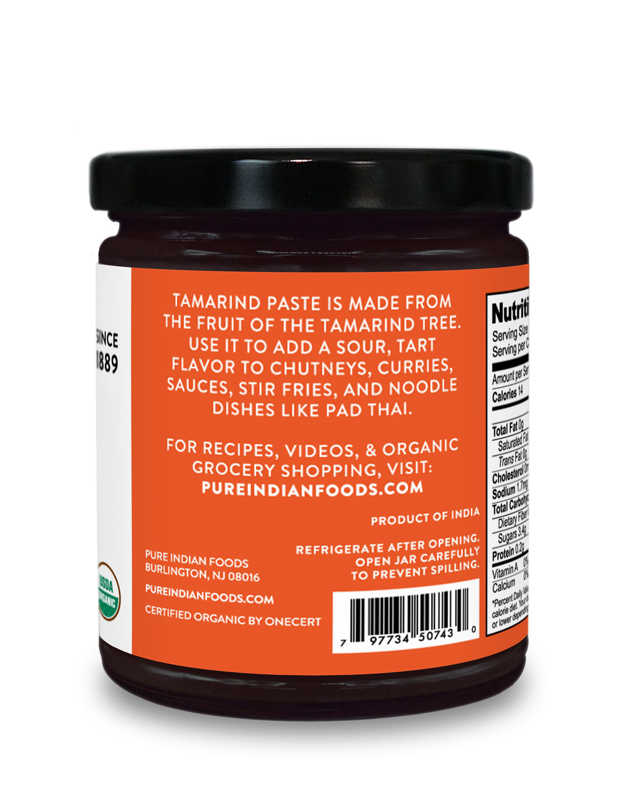 Side label on a jar of organic tamarind concentrate from Pure Indian Foods saying that tamarind paste is made from the fruit of the Tamarind tree and can be used to add a sour, tart flavor to chutneys, curries, sauces, stir fries, and noodle dishes like pad Thai.