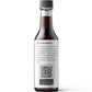 A bottle of Hing Recipe Vegan Worcestershire sauce with a dark label and a gray cap, shown on a clean white background with a soft shadow.