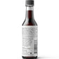A dark glass bottle of Hing Recipe Vegan Worcestershire sauce shown from the back, featuring a white nutrition facts label and a black cap, set against a plain white background.
