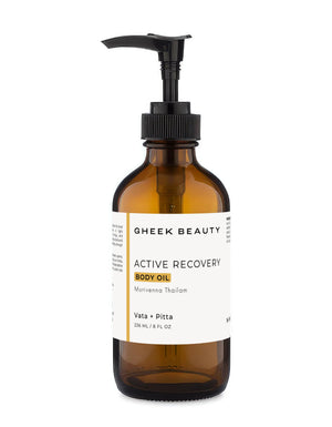 An amber glass pump bottle of Gheek Beauty Active Recovery Body Oil with a black pump and a white label, shown on a plain white background.