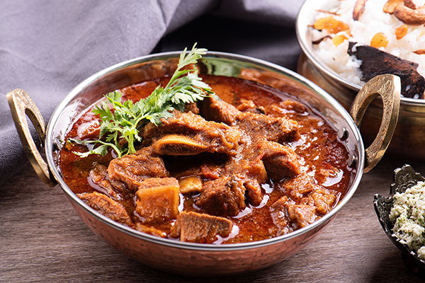 This stunning yet easy pork or beef curry is being served in our karahi stainless steel and copper serving bowl. The curry dish is made with the best tamarind paste you can get! (Hint: it's ours. From Pure Indian Foods.)