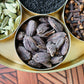 Organic Black Cardamom Pods in a brass masala dabba among other spices from Pure Indian Foods