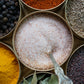 Himalayan Pink Salt from Pure Indian Foods, fine ground, in a masala dabba among other organic spices.