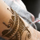 Applying pure henna powder for skin as a temporary tattoo.
