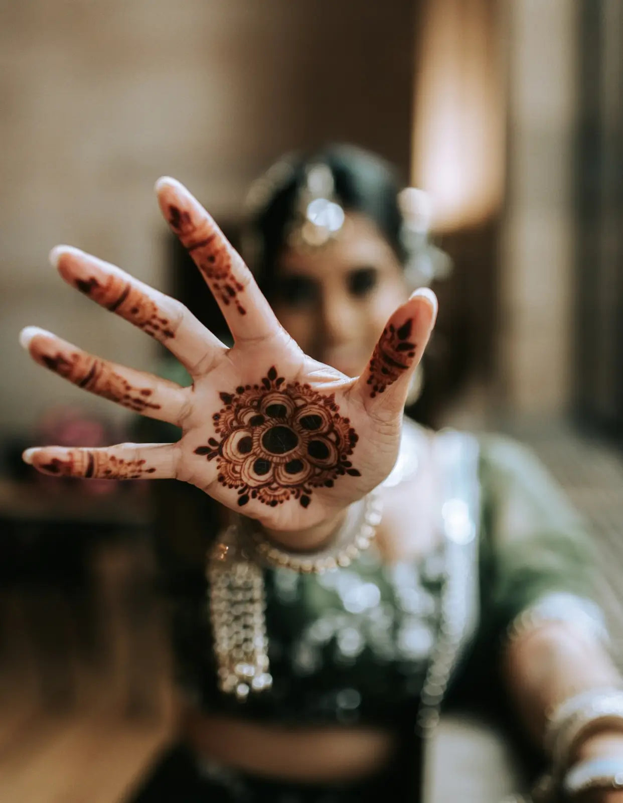 A temporary tattoo on a hand created by using henna powder for skin.