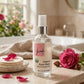 A spray bottle of Organic Rose Water on a bathroom counter