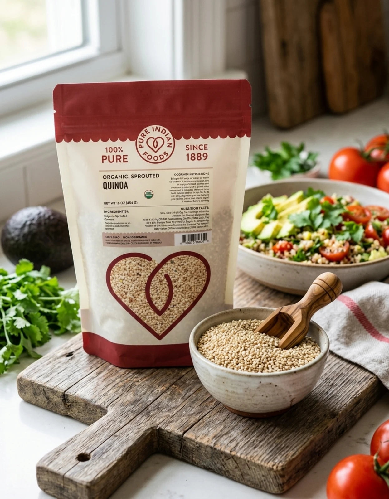 A pouch of Organic Sprouted Quinoa on a wooden board next to a bowl of cooked quinoa salad and a bowl of the uncooked grain