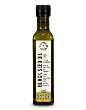 Bottle of Pure Indian Foods organic black seed oil. Label says it's extracted from Nigella Sativa, "The Seed of Blessing," with notes of black pepper and oregano. It is Organic, Virgin, Cold-pressed, Paleo, Vegan, Non-GMO, and Gluten-Free. 250ml bottle.