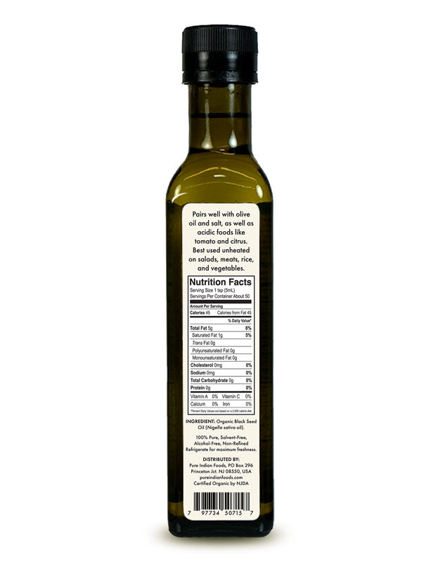 Back label of Pure Indian Foods Organic Black Seed Oil. Says it "Pairs well with olive oil and salt, as well as acidic foods like tomato and citrus. Best used unheated on salads, meats, rice, and vegetables." Nutrition Facts clearly seen.