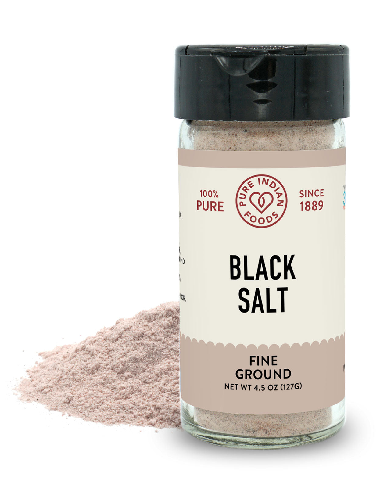 4.5 oz glass jar of Pure Indian Foods Black Salt, showing that it takes on a pink hue when ground.