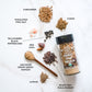 A birds eye view of the whole spices that go into the Pure Indian Foods Bombay Chaat Masala DIY blend, all on a marble background. Spices include coriander, Himalayan Pink salt, Tellicherry Black Peppercorns, red Chili, Amchoor, Ajwain, black salt, and cumin.