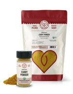 Organic Curry Powder Seasoning Blend from Pure Indian Foods. An 8oz bag and a 2.4oz glass jar of the curry seasoning are on display.