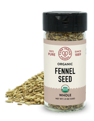 A jar of organic fennel seed from Pure Indian Foods is placed in front of a small pile of whole fennel seeds on a white background.