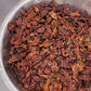 A bowl of whole dried organic smoked ghost peppers