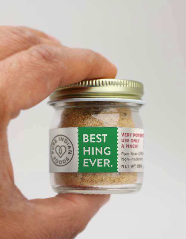 jar of asafetida being held in someone's hand. You can see the Best Hing Ever label.