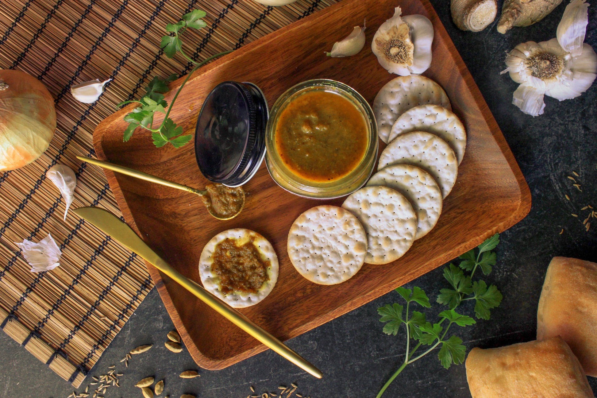 Our gluten-free organic Indian simmer sauce artfully displayed on a serving tray with crackers.
