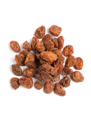 a handful of large monukka raisins from Pure Indian Foods on a  white background