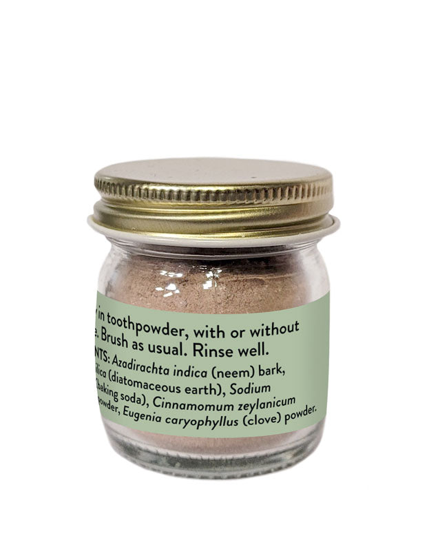 Instruction label on a jar of Pure Indian Foods Neem Bark Powder for teeth. It says to dip your toothbrush in the toothpowder, iwth or without toothpaste, then brush as usual and rinse well.
