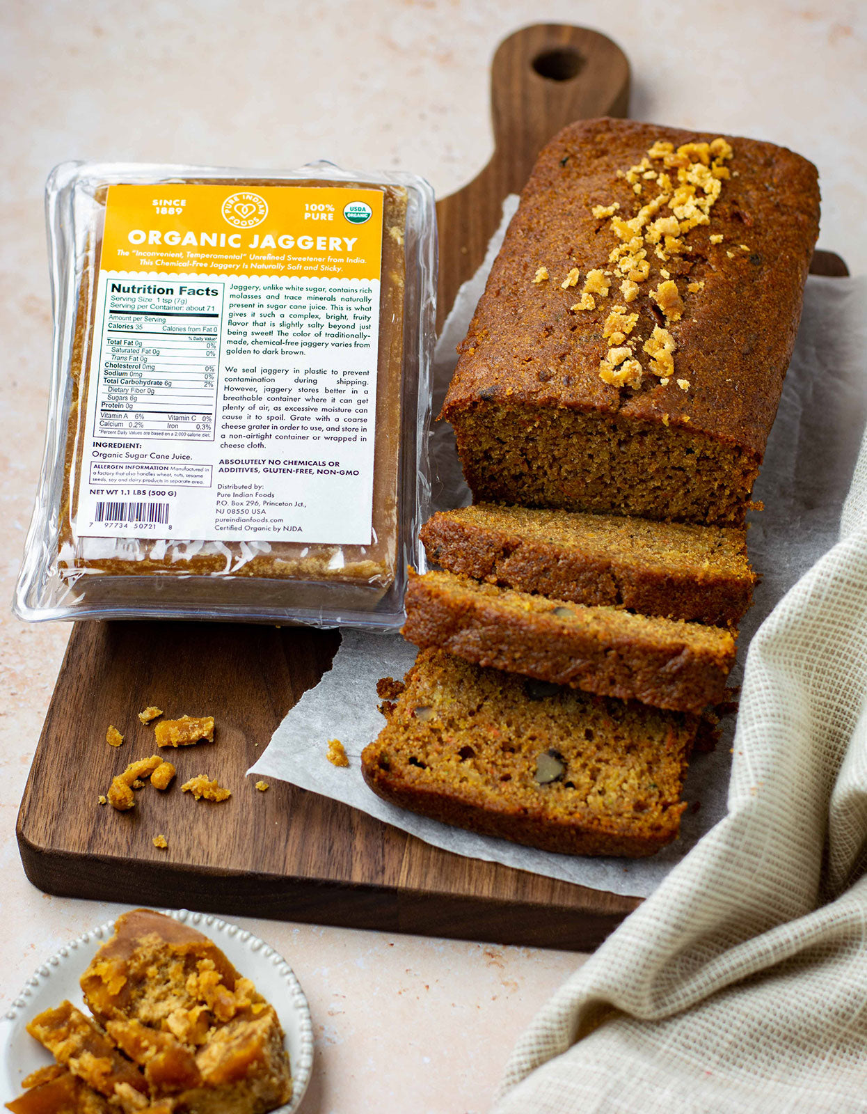 Photo of Pure Indian Foods Organic Jaggery, also known as panela or rapadura, next to a loaf of bread that was baked with it.