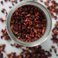 Birds eye view of an opened jar of dried pomegranate seeds from Pure Indian Foods.