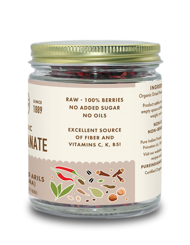 Side label on a jar of Pure Indian Foods dried pomegranate seeds. Label says they are: raw - 100% berries, no added sugar, no oils.