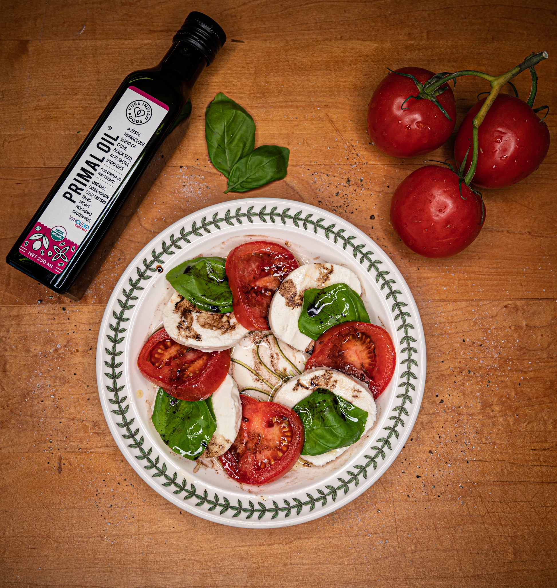 Birds eye view of a plate of caprese salad made with Primal Oil from Pure Indian Foods