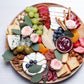 Gorgeous charcuterie board featuring an array of meats, cheeses, and fresh fruits, pairs with our organic rose petal jam.