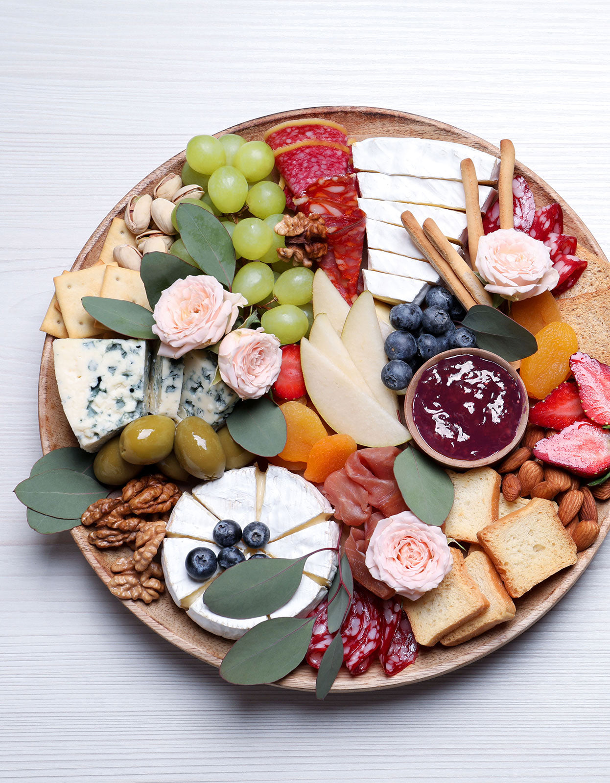 Gorgeous charcuterie board featuring an array of meats, cheeses, and fresh fruits, pairs with our organic rose petal jam.