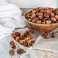 Bowl of organic soap nuts from Pure Indian Foods with a muslin bag for laundry.