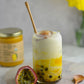 alphonso mango boba drink with a jar of organic alphonso mango puree containing 100% pure organic mango pulp in the background