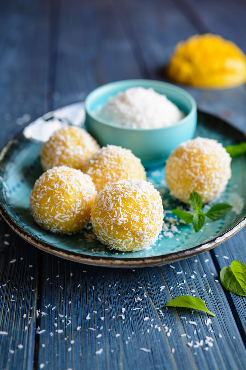 Mango Coconut Ladoos artfully displayed on a cute plate. Made with our Alphonso Mango Puree.
