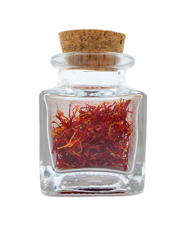 Glass jar of Pure Indian Foods Organic Saffron, showing the vibrantly colored threads visible inside the glass.