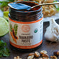 Open jar of organic tamarind Paste from Pure Indian Foods, with a spoon dipped into it. Label says it's perfect for adding sour and tart taste to your food.